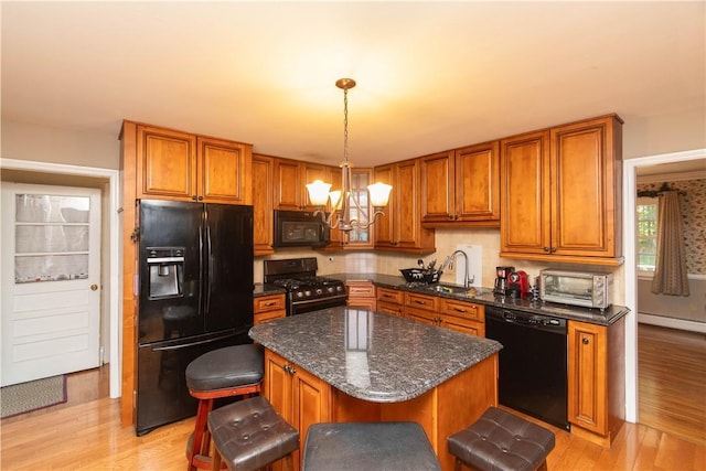36 Boulder Dr, Cornwall, NY 12553 - kitchen with black appliances, a chandelier, brown cabinets, light wood-type flooring, and a sink