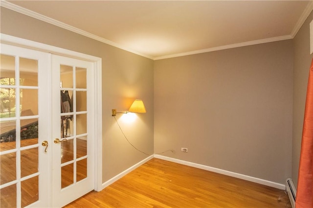 36 Boulder Dr, Cornwall, NY 12553 - empty room featuring french doors, light wood-style flooring, a baseboard heating unit, baseboards, and ornamental molding