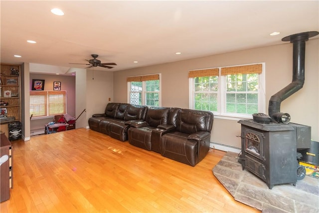 36 Boulder Dr, Cornwall, NY 12553 - living room featuring a wood stove, light wood-style flooring, a baseboard heating unit, ceiling fan, and recessed lighting
