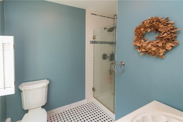 bathroom with tile patterned floors, toilet, an enclosed shower, and sink