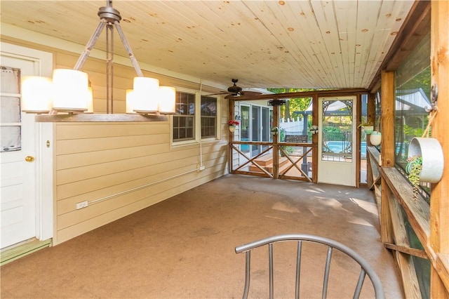 unfurnished sunroom with ceiling fan and wood ceiling