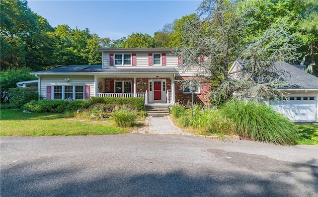 view of front of home with a porch and a garage