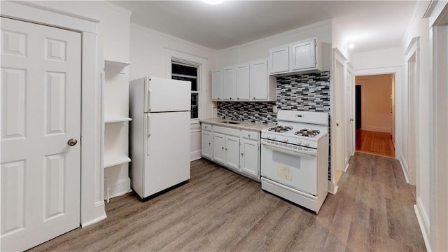 kitchen featuring crown molding, light hardwood / wood-style floors, white appliances, decorative backsplash, and white cabinets