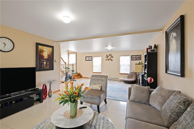 living room featuring light tile patterned flooring and baseboard heating