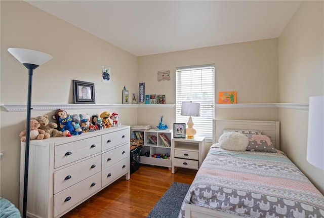 bedroom with dark wood-type flooring