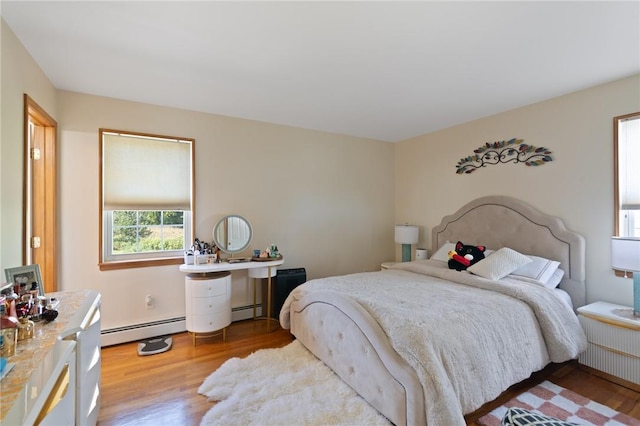 bedroom featuring light hardwood / wood-style floors and baseboard heating