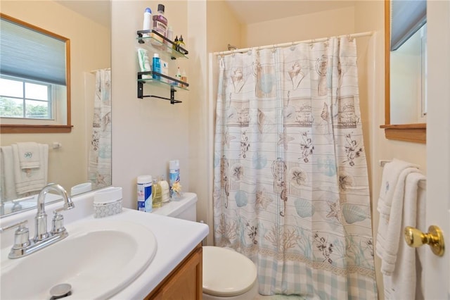 bathroom with a shower with curtain, vanity, and toilet