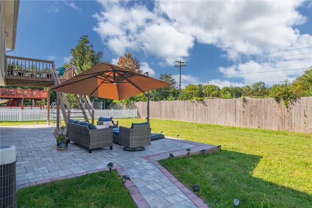 view of yard with outdoor lounge area, a patio area, and central air condition unit