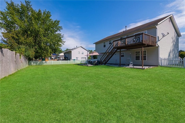 back of house featuring a yard and a deck