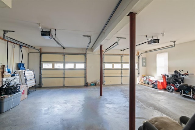 garage with electric panel and a garage door opener