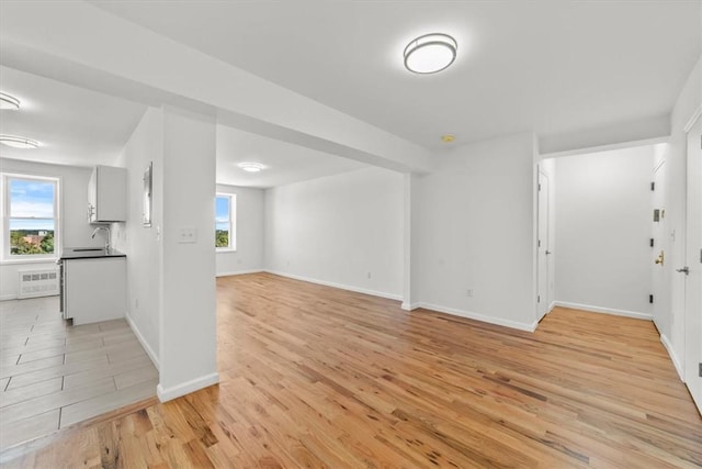 90 Union St Unit 6G, New Rochelle, NY 10805 - unfurnished living room with plenty of natural light, light wood-type flooring, and sink