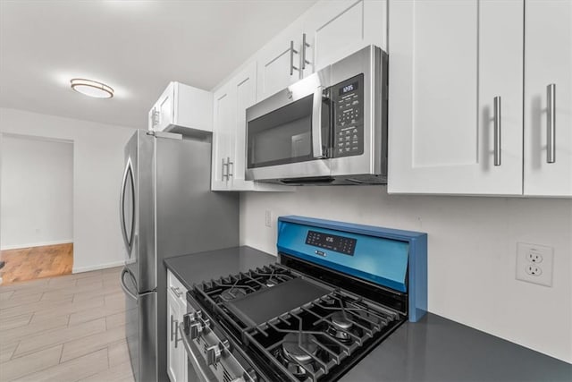 90 Union St Unit 6G, New Rochelle, NY 10805 - kitchen featuring white cabinetry, stainless steel appliances, and light hardwood / wood-style flooring