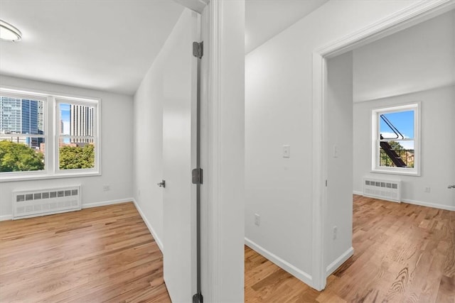 90 Union St Unit 6G, New Rochelle, NY 10805 - hallway with radiator and light hardwood / wood-style floors