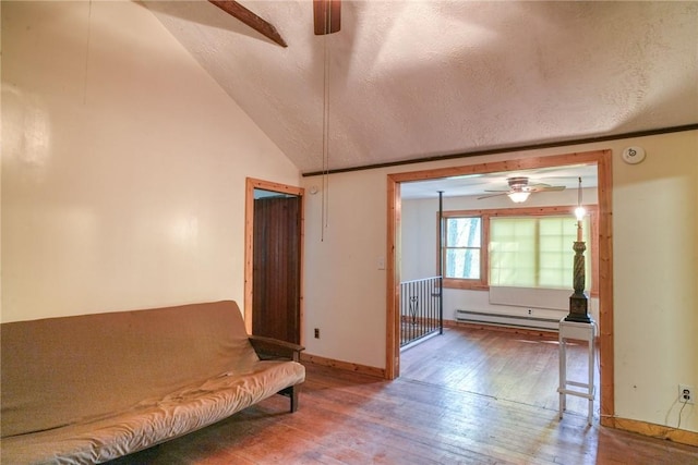 unfurnished room featuring lofted ceiling, ceiling fan, wood-type flooring, a textured ceiling, and a baseboard radiator