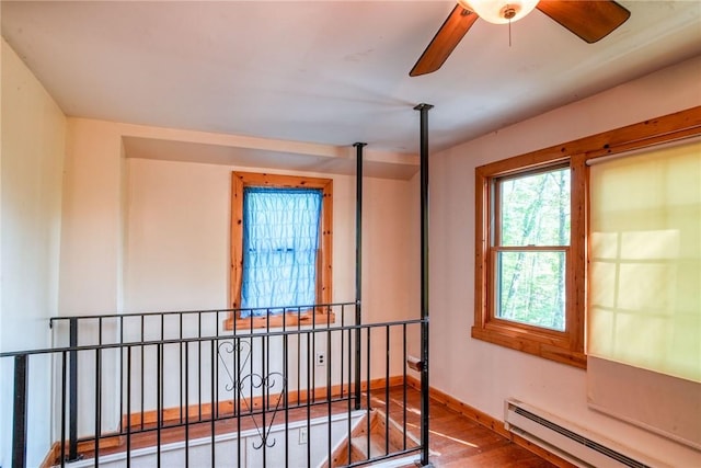 bedroom with hardwood / wood-style flooring and a baseboard radiator