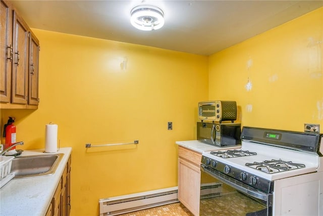 kitchen with sink, a baseboard radiator, and white range with gas stovetop