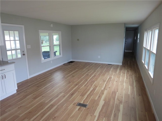 unfurnished living room featuring light hardwood / wood-style floors