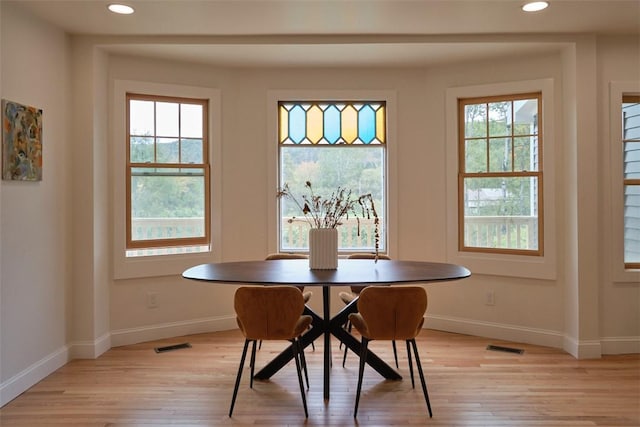 dining area with a wealth of natural light, light hardwood / wood-style flooring, and breakfast area