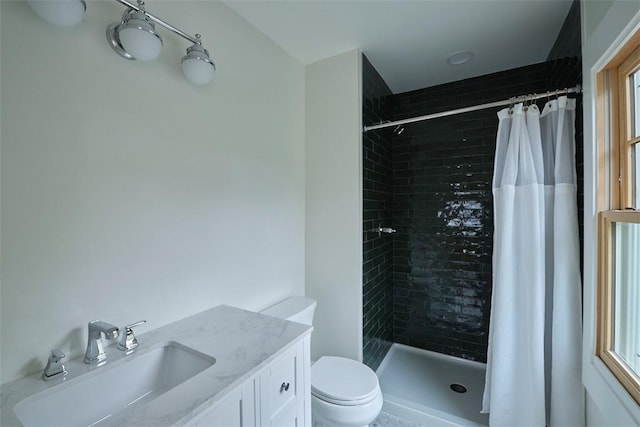 bathroom with vanity, toilet, and curtained shower