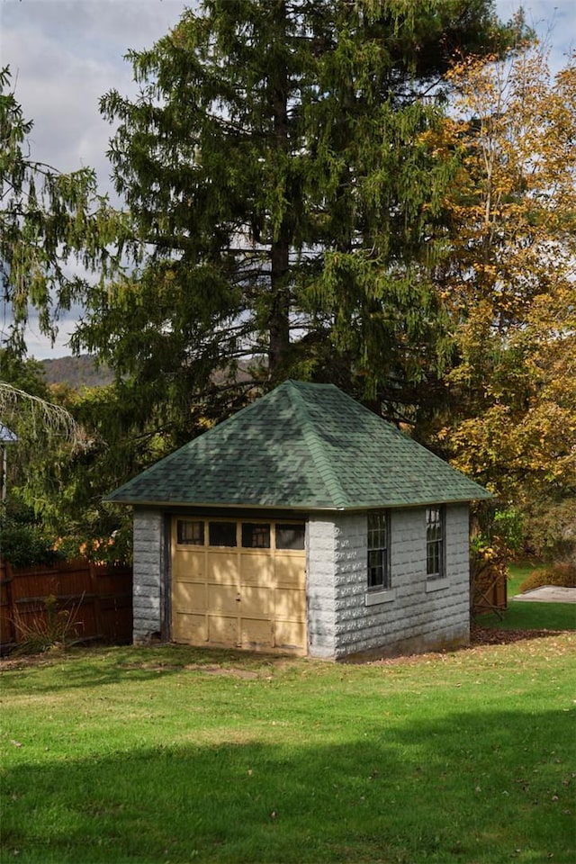 view of outbuilding with a lawn and a garage