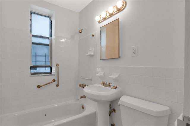 bathroom featuring toilet, tile walls, and tiled shower / bath