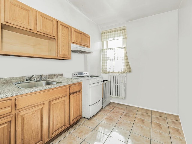 kitchen featuring radiator, white gas stove, light tile patterned floors, and sink