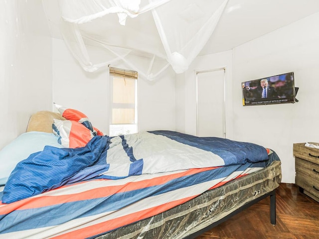 bedroom featuring dark parquet flooring and ceiling fan