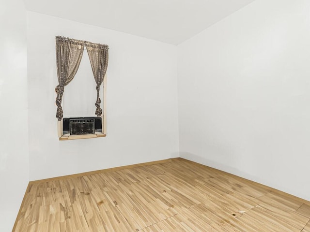 unfurnished room with hardwood / wood-style floors