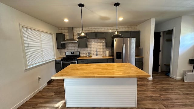 kitchen featuring wooden counters, stainless steel appliances, wall chimney exhaust hood, and dark wood-type flooring