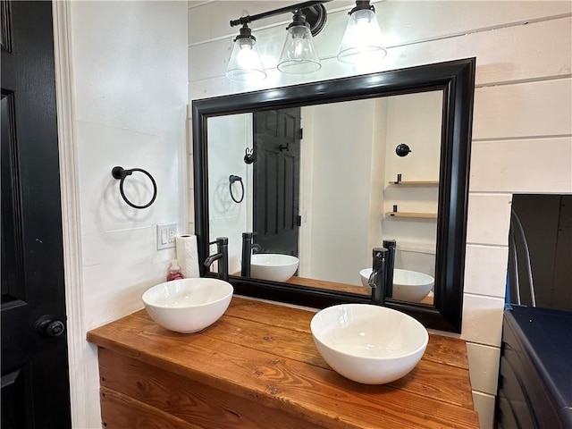 full bathroom with double vanity and a sink