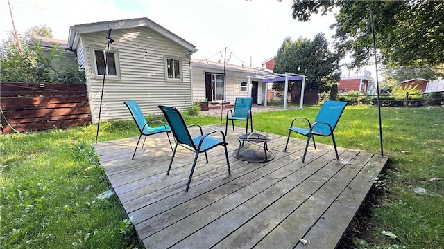 wooden terrace with a yard, a fire pit, a fenced backyard, and a pergola