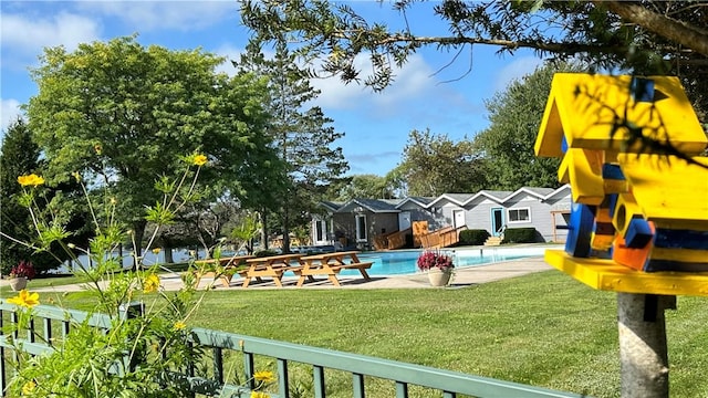 exterior space with a lawn and an outdoor pool