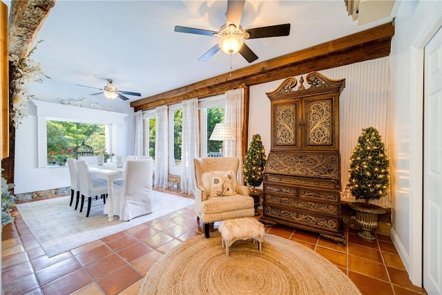 living area featuring ceiling fan, tile patterned flooring, and a healthy amount of sunlight