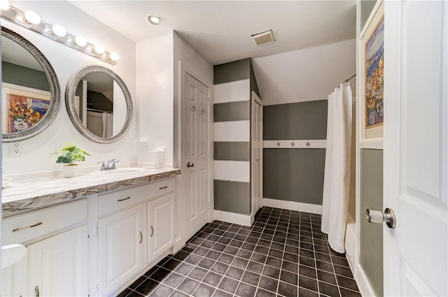 bathroom featuring tile patterned flooring, vanity, and shower / bathtub combination with curtain