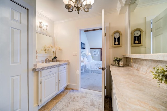 bathroom featuring a notable chandelier, vanity, and crown molding