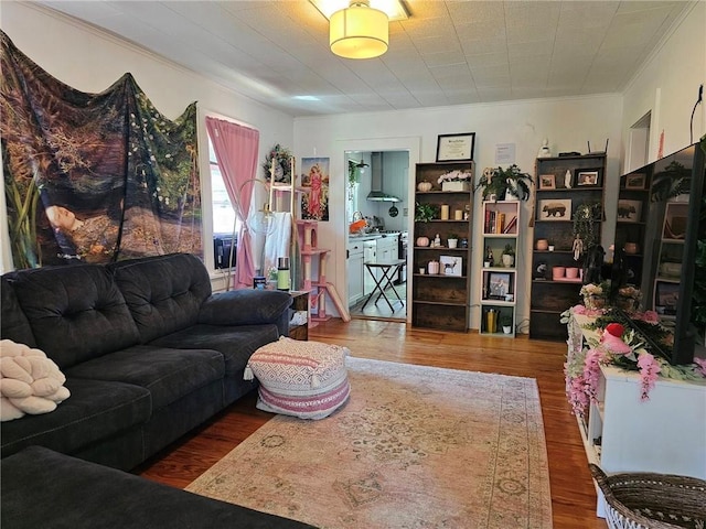 living room with dark hardwood / wood-style flooring and crown molding