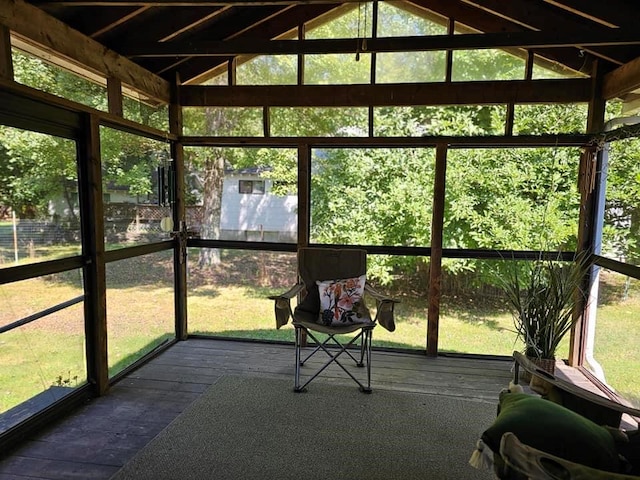 unfurnished sunroom with plenty of natural light and lofted ceiling