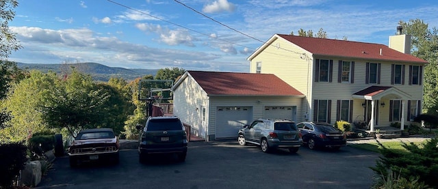 view of front facade with a mountain view and a garage