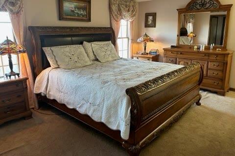 carpeted bedroom with multiple windows