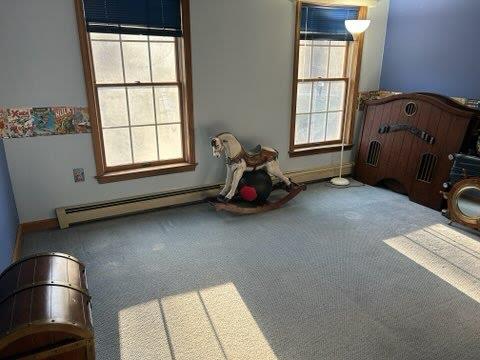 bedroom featuring carpet floors and baseboard heating