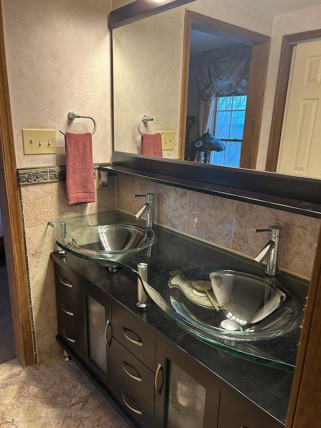 bathroom with vanity and decorative backsplash