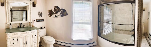 bathroom featuring baseboard heating, vanity, a shower with shower door, and toilet