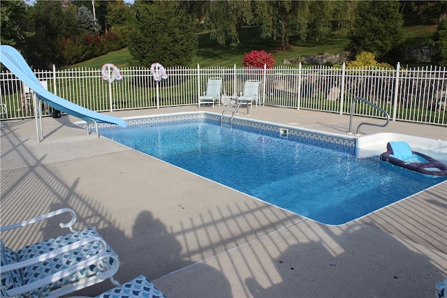 view of pool with a patio and a water slide