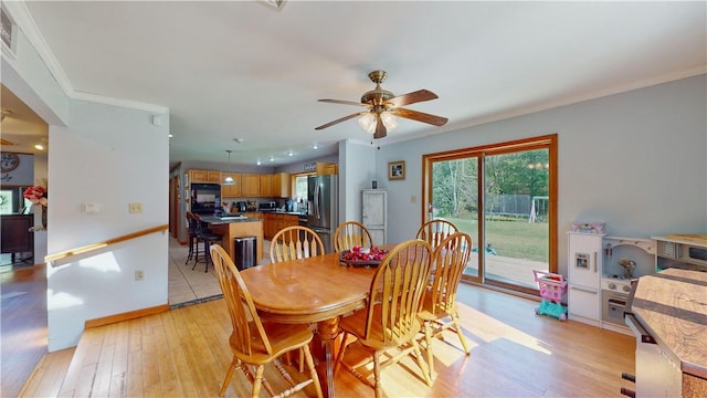 dining area with ceiling fan, light hardwood / wood-style flooring, and crown molding