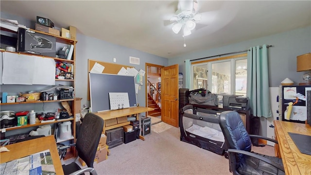 office space with light colored carpet and ceiling fan