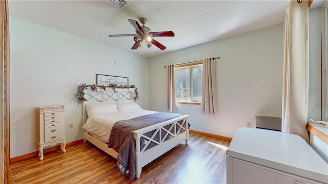 bedroom with ceiling fan and wood-type flooring