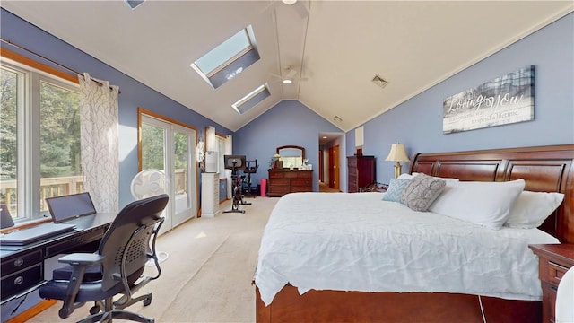 bedroom featuring light carpet and lofted ceiling with skylight