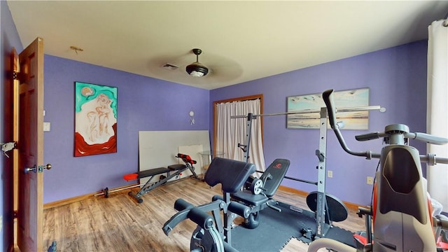 exercise area featuring hardwood / wood-style flooring and ceiling fan