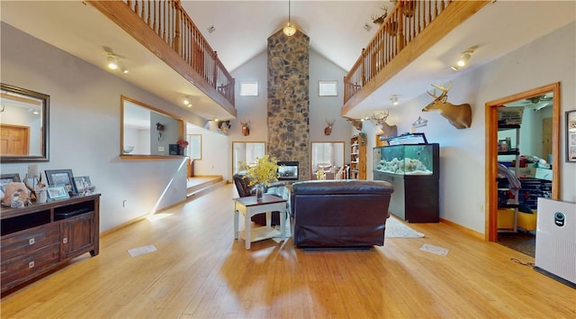 75 Monahan Rd, Port Jervis, NY 12771 - living area featuring high vaulted ceiling, hardwood / wood-style floors, baseboards, plenty of natural light, and stairs