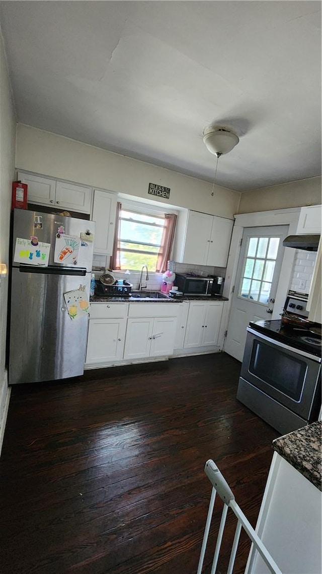 kitchen with stainless steel refrigerator and a towering ceiling